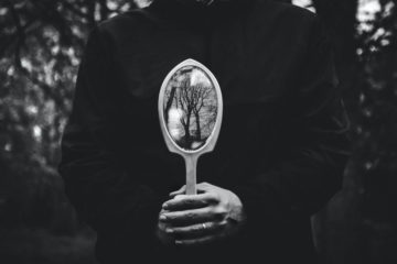 man holding miror